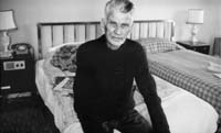 Samuel Beckett seated in Room 604,